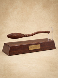 Quillhex magnetic broom pen floating beside its rounded clear upright